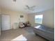 Spacious bedroom with large window, ceiling fan, and ample space for furniture at 12090 Malaga Ave, North Port, FL 34287