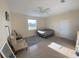 Bedroom with neutral walls, tile flooring, a comfortable bed, and seating area at 12090 Malaga Ave, North Port, FL 34287