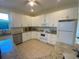Spacious kitchen with white shaker cabinets, granite counters, and stainless steel appliances at 12090 Malaga Ave, North Port, FL 34287