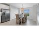 Bright dining area with a farmhouse table and wicker chairs at 14224 Heritage Landing Blvd # 926, Punta Gorda, FL 33955