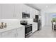 Modern kitchen with stainless steel appliances and white cabinetry at 14224 Heritage Landing Blvd # 926, Punta Gorda, FL 33955