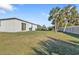 Large fenced backyard with grill and palm trees at 18043 Avonsdale Cir, Port Charlotte, FL 33948