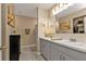 Bathroom with double sinks, gray vanity, and tile flooring with an adjacent walk-in shower at 18043 Avonsdale Cir, Port Charlotte, FL 33948