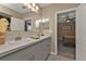 Bathroom featuring double sinks and gray cabinets at 18043 Avonsdale Cir, Port Charlotte, FL 33948