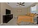 Main bedroom with large bed, dresser, and ceiling fan at 18043 Avonsdale Cir, Port Charlotte, FL 33948