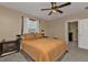 Comfortable bedroom features a ceiling fan, neutral paint, and good natural light from window at 18043 Avonsdale Cir, Port Charlotte, FL 33948
