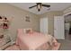 Light pink bedroom with a full-size bed and ceiling fan at 18043 Avonsdale Cir, Port Charlotte, FL 33948