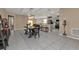 Dining room with black table and bench, view of kitchen and living room at 18043 Avonsdale Cir, Port Charlotte, FL 33948