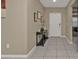 Inviting foyer with tiled floors and a stylish console table at 18043 Avonsdale Cir, Port Charlotte, FL 33948