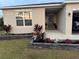 Inviting entrance with plants and colorful flowers by the front door at 18043 Avonsdale Cir, Port Charlotte, FL 33948
