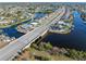 Aerial view showcasing home's location near canal and bridge at 21062 Edgewater Dr, Port Charlotte, FL 33952