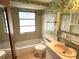 Clean bathroom with bathtub, sink, and floral wallpaper at 21062 Edgewater Dr, Port Charlotte, FL 33952