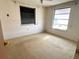 Bedroom featuring two windows and neutral carpeting at 21062 Edgewater Dr, Port Charlotte, FL 33952