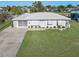 White single story home with attached garage and manicured lawn at 21062 Edgewater Dr, Port Charlotte, FL 33952