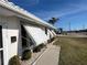 View of a light-colored home with multiple windows and awnings at 21062 Edgewater Dr, Port Charlotte, FL 33952