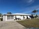 Single story home with attached garage and well-maintained lawn at 21062 Edgewater Dr, Port Charlotte, FL 33952