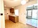 Simple kitchen featuring wood cabinets, and access to the sunroom at 21062 Edgewater Dr, Port Charlotte, FL 33952