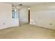 Bright living room with neutral carpeting and a partial view of the dining area at 21062 Edgewater Dr, Port Charlotte, FL 33952