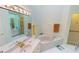 Primary bathroom with double sinks, soaking tub, and separate shower at 26247 Stillwater Cir, Punta Gorda, FL 33955