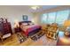 Main bedroom with a king-size bed, massage chair, and water views at 26247 Stillwater Cir, Punta Gorda, FL 33955