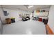 Garage with golf cart, storage cabinets and additional space at 26247 Stillwater Cir, Punta Gorda, FL 33955
