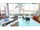 Spacious screened lanai overlooking a lake with seating and dining areas at 26247 Stillwater Cir, Punta Gorda, FL 33955