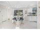 Dining area with white tile flooring, white wicker chairs, and a view of the kitchen at 279 Mariner Ln, Rotonda West, FL 33947