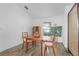 Simple dining area with wooden table and chairs, a room divider, and a nature painting at 3119 Amanda St, Punta Gorda, FL 33950