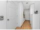 White hallway with storage and wood flooring at 341 Severin Se Rd, Port Charlotte, FL 33952