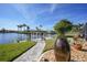 Landscaped waterfront backyard with a firepit and a stone pathway at 355 Belaire Ct, Punta Gorda, FL 33950