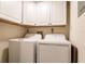 Laundry room with washer, dryer, and white cabinets at 379 Coldeway Dr # H16, Punta Gorda, FL 33950