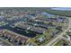 Wide aerial view showing condo building, tennis court, and waterway at 4000 Bal Harbor Blvd # 126, Punta Gorda, FL 33950