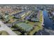 Aerial view of community, highlighting tennis court and canal at 4000 Bal Harbor Blvd # 126, Punta Gorda, FL 33950