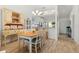 Light and airy dining room with a farmhouse table and view of kitchen at 4000 Bal Harbor Blvd # 126, Punta Gorda, FL 33950
