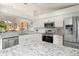 Modern kitchen with stainless steel appliances and granite counters at 4000 Bal Harbor Blvd # 126, Punta Gorda, FL 33950