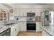 Modern kitchen with stainless steel appliances and granite counters at 4000 Bal Harbor Blvd # 126, Punta Gorda, FL 33950