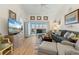 Bright living room with comfy seating, large TV, and access to a screened balcony at 4000 Bal Harbor Blvd # 126, Punta Gorda, FL 33950