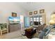 Living room features hardwood floors, a large TV, and balcony access at 4000 Bal Harbor Blvd # 126, Punta Gorda, FL 33950