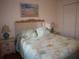 Bedroom with queen bed and ocean decor at 4048 Oakview Dr # F2-3, Punta Gorda, FL 33980
