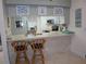 View of kitchen with breakfast bar and two chairs at 4048 Oakview Dr # F2-3, Punta Gorda, FL 33980