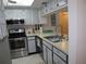 Stainless steel appliances and light blue cabinets in a galley kitchen at 4048 Oakview Dr # F2-3, Punta Gorda, FL 33980