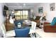 Bright living room with comfy seating, glass dining table, and access to a balcony overlooking the water at 4048 Oakview Dr # F2-3, Punta Gorda, FL 33980