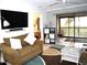 Living room features a brown sofa, coffee table, and a view of the bedroom and balcony at 4048 Oakview Dr # F2-3, Punta Gorda, FL 33980