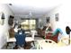Bright living room with seating area, dining table, and view to balcony at 4048 Oakview Dr # F2-3, Punta Gorda, FL 33980