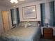 Main bedroom with a large bed, plenty of light, and teal curtains at 4048 Oakview Dr # F2-3, Punta Gorda, FL 33980