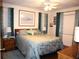Main bedroom with a large bed, plenty of light, and teal curtains at 4048 Oakview Dr # F2-3, Punta Gorda, FL 33980