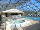 Enclosed heated pool with spa and lounge chairs at 4048 Oakview Dr # F2-3, Punta Gorda, FL 33980