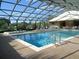 Enclosed heated pool with spa and lounge chairs at 4048 Oakview Dr # F2-3, Punta Gorda, FL 33980