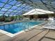 Enclosed heated pool with spa and lounge chairs at 4048 Oakview Dr # F2-3, Punta Gorda, FL 33980