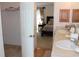 Double vanity bathroom with walk-in closet and wood cabinetry at 4692 Hillman Ter, North Port, FL 34288